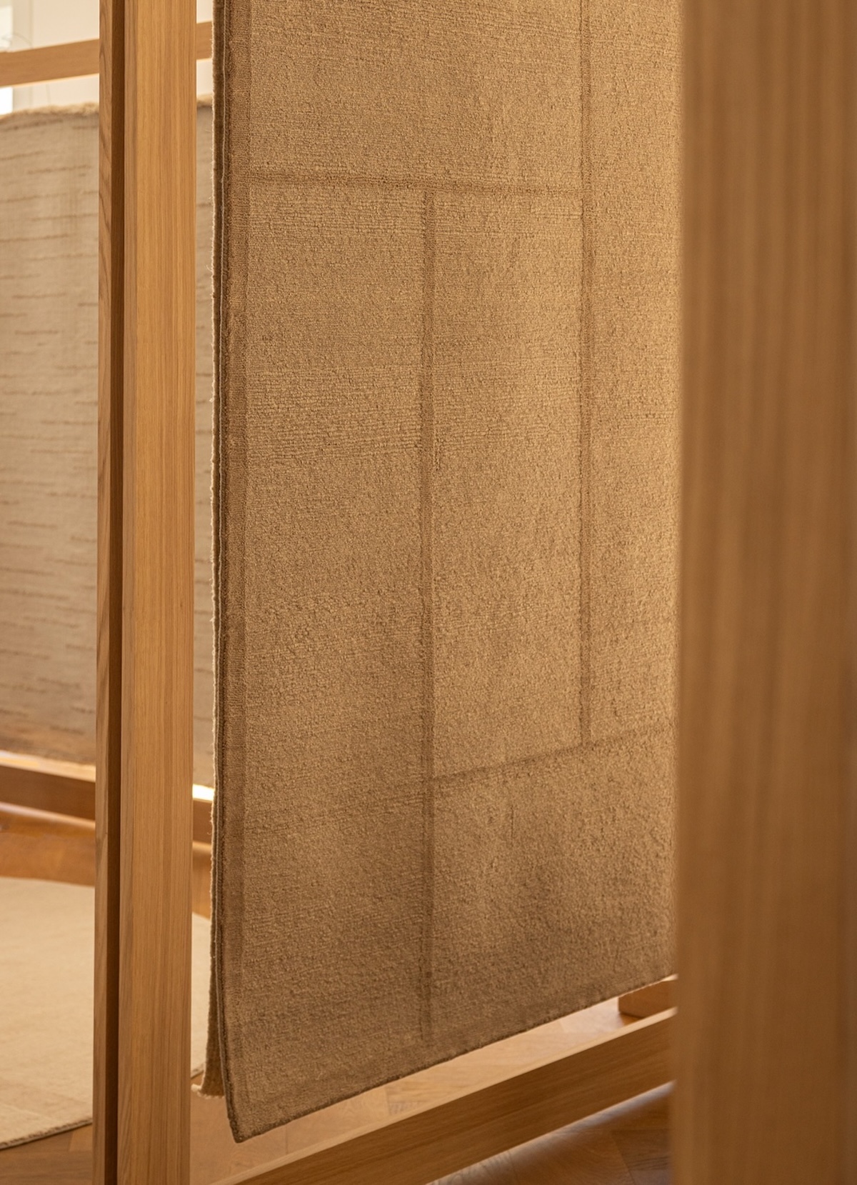 Echoes of Texture exhibition by Linie Design and Karimoku Case at 3 Days of Design 2025, featuring handwoven rugs from the Woven Matter collection displayed on wooden frames inspired by Japanese Shinto gateways, with contributions from Norm Architects, Urd Moll Gundermann, Foster + Partners, and Keiji Ashizawa Design