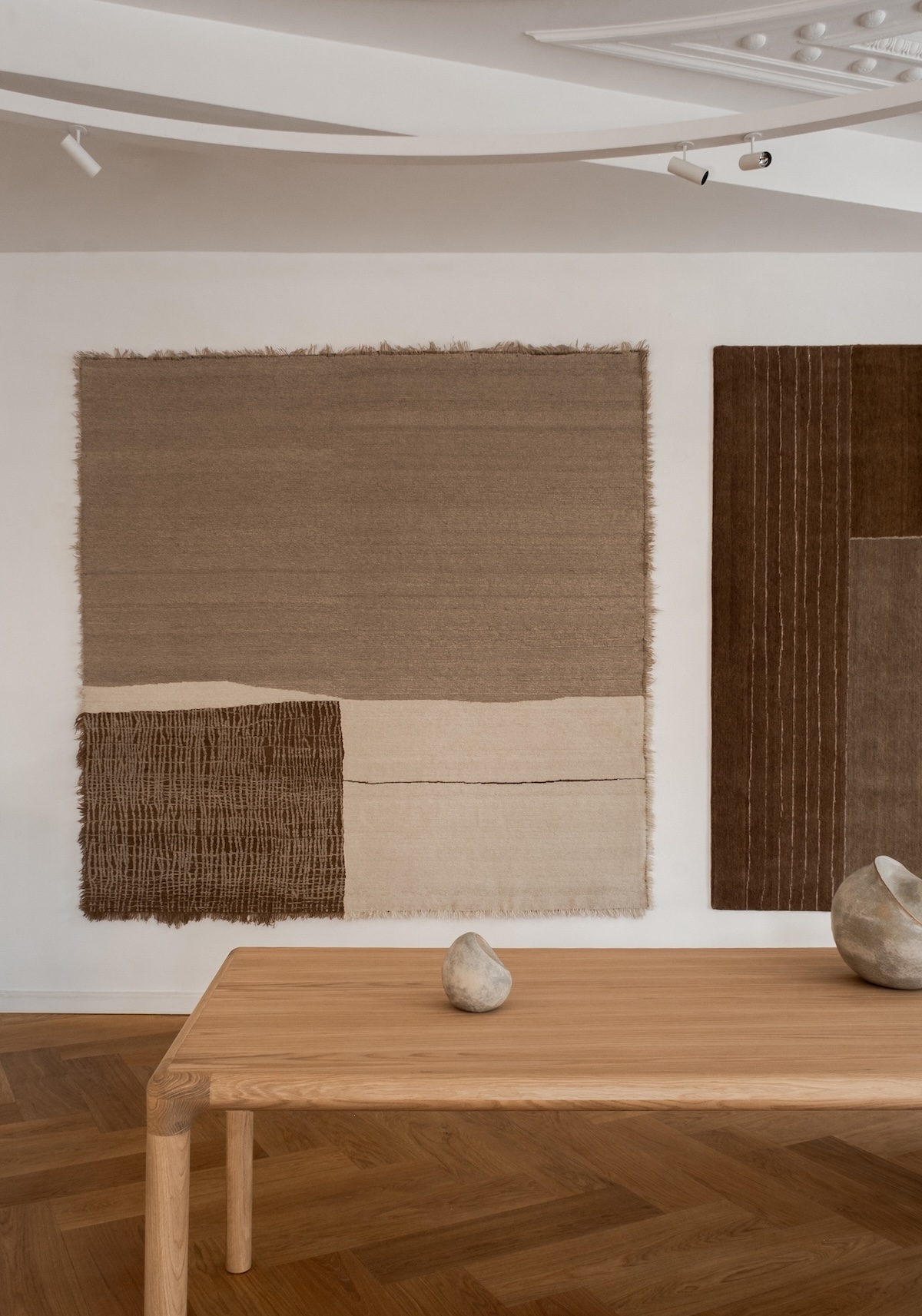 Echoes of Texture exhibition by Linie Design and Karimoku Case at 3 Days of Design 2025, featuring handwoven rugs from the Woven Matter collection displayed on wooden frames inspired by Japanese Shinto gateways, with contributions from Norm Architects, Urd Moll Gundermann, Foster + Partners, and Keiji Ashizawa Design
