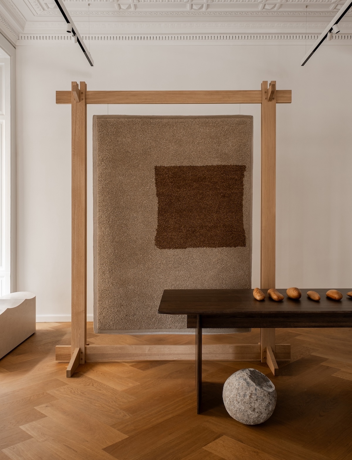 Echoes of Texture exhibition by Linie Design and Karimoku Case at 3 Days of Design 2025, featuring handwoven rugs from the Woven Matter collection displayed on wooden frames inspired by Japanese Shinto gateways, with contributions from Norm Architects, Urd Moll Gundermann, Foster + Partners, and Keiji Ashizawa Design