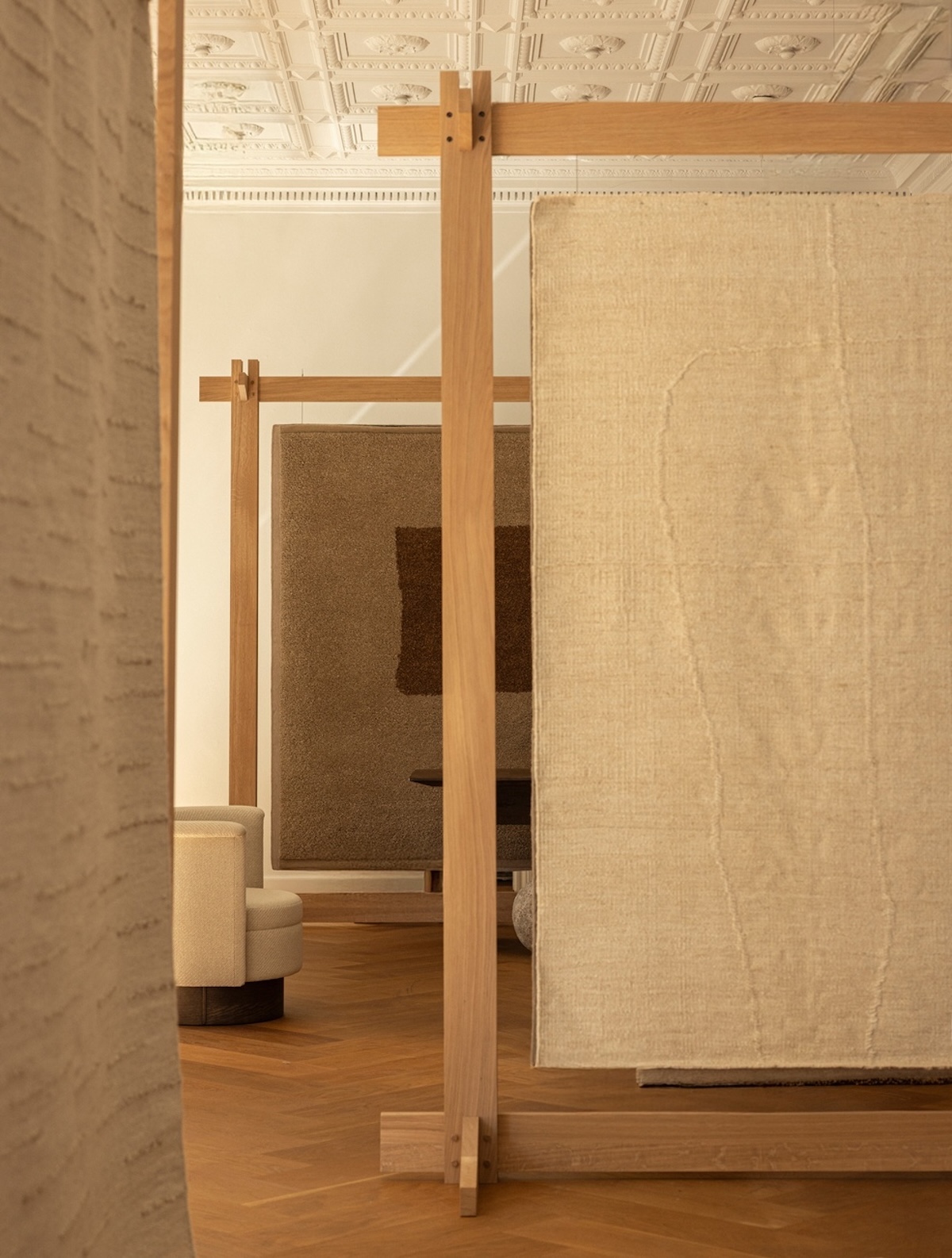 Echoes of Texture exhibition by Linie Design and Karimoku Case at 3 Days of Design 2025, featuring handwoven rugs from the Woven Matter collection displayed on wooden frames inspired by Japanese Shinto gateways, with contributions from Norm Architects, Urd Moll Gundermann, Foster + Partners, and Keiji Ashizawa Design
